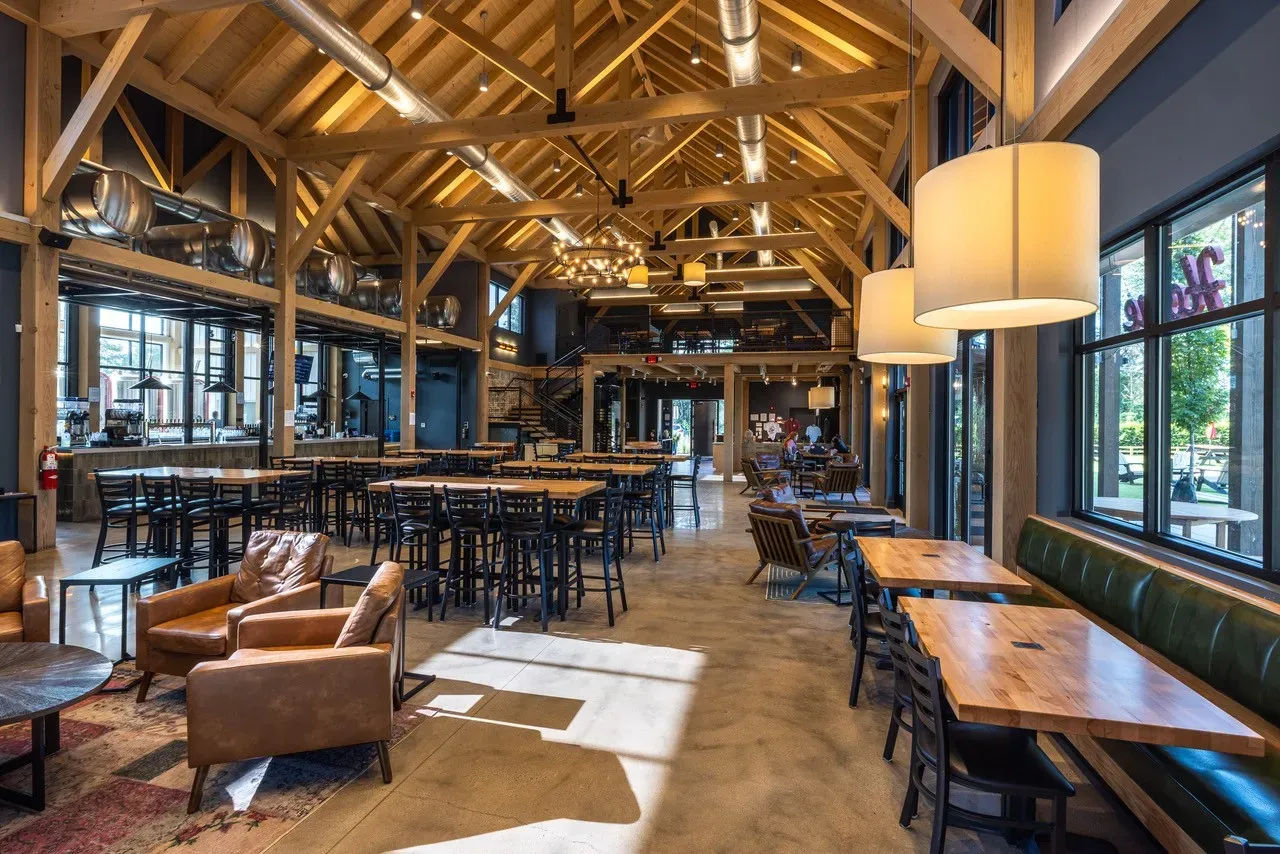 Lark Brewing Co taproom interior with exposed timber beams from original 1920s dairy barn